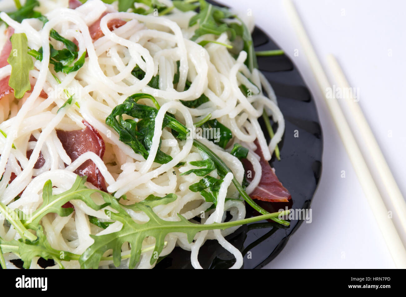 Pasta with prosciutto and arugula vegetable close up Stock Photo
