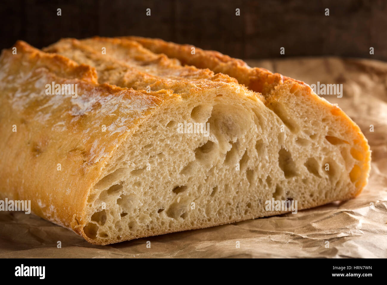 Close up of piece of fresh bread on paper Stock Photo