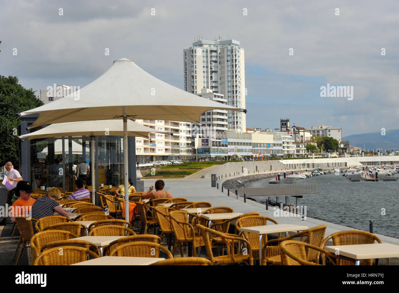 Eating in outside restaurant by waterfront and harbour in Ponta Delgada