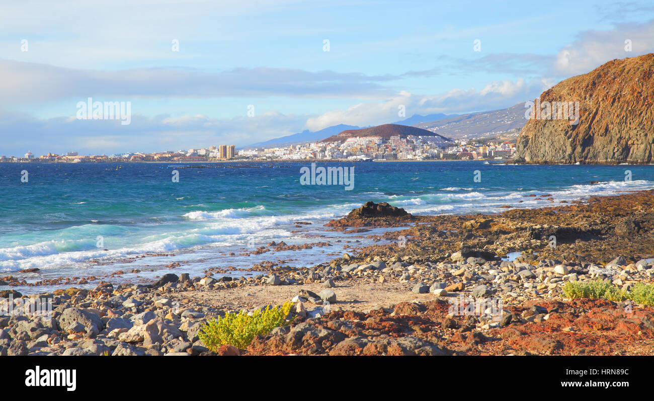 Stony beach and Las Americas and Los Cristianos towns in the background, Tenerife Island, Canaries Stock Photo