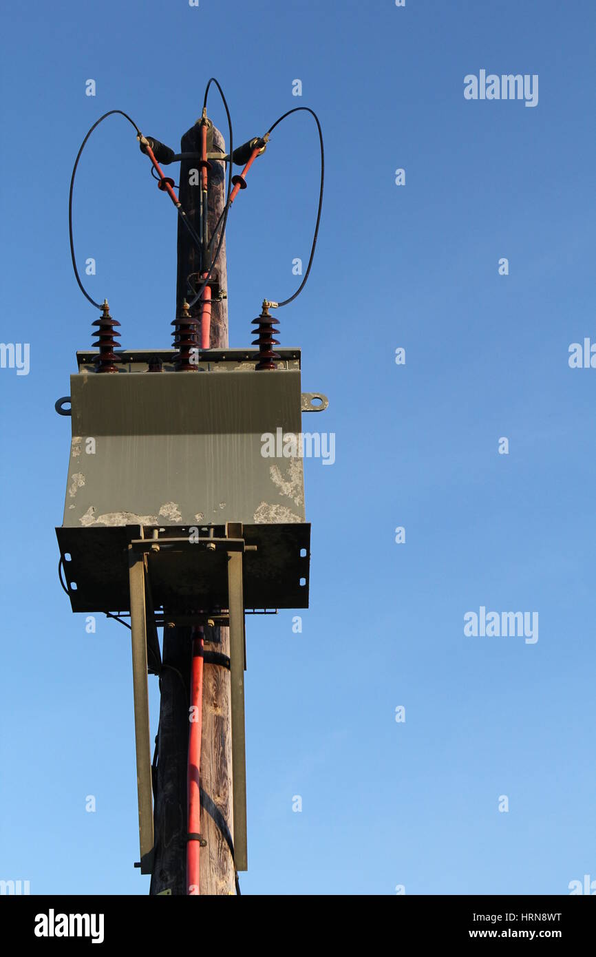 Wooden Pole Mounted Electricity Substation Transformer and Overhead Power Lines, UK Stock Photo