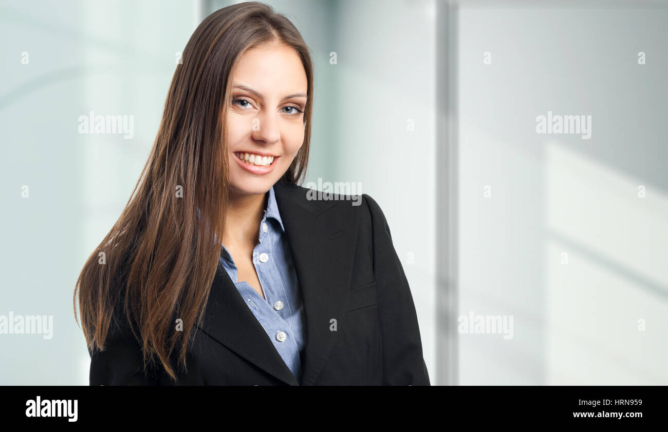 Smiling young business woman Stock Photo - Alamy
