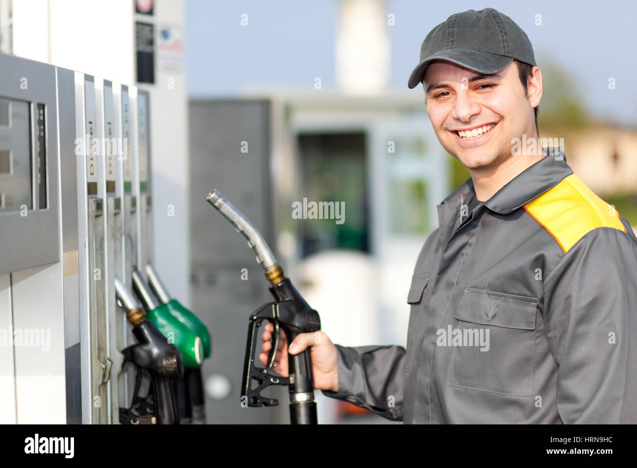 Smiling worker at the gas station Stock Photo - Alamy