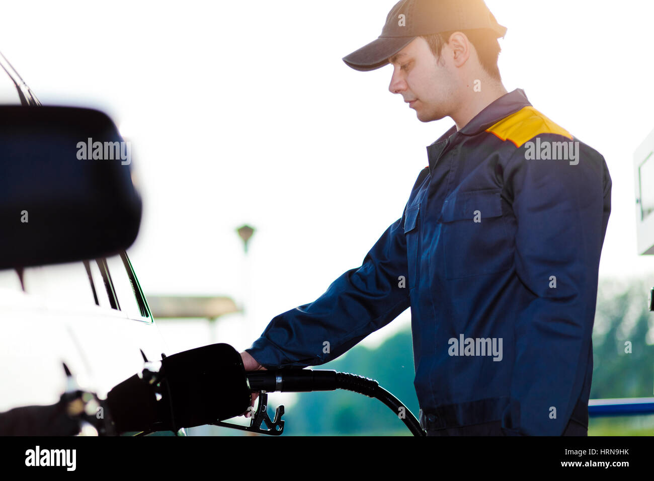 Gas station worker refilling car at service station Stock Photo - Alamy
