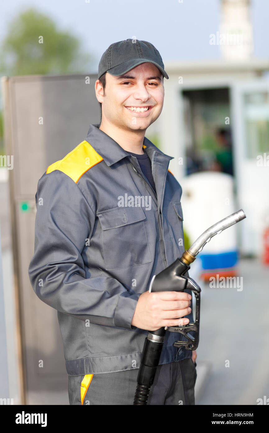 Smiling worker at the gas station Stock Photo - Alamy