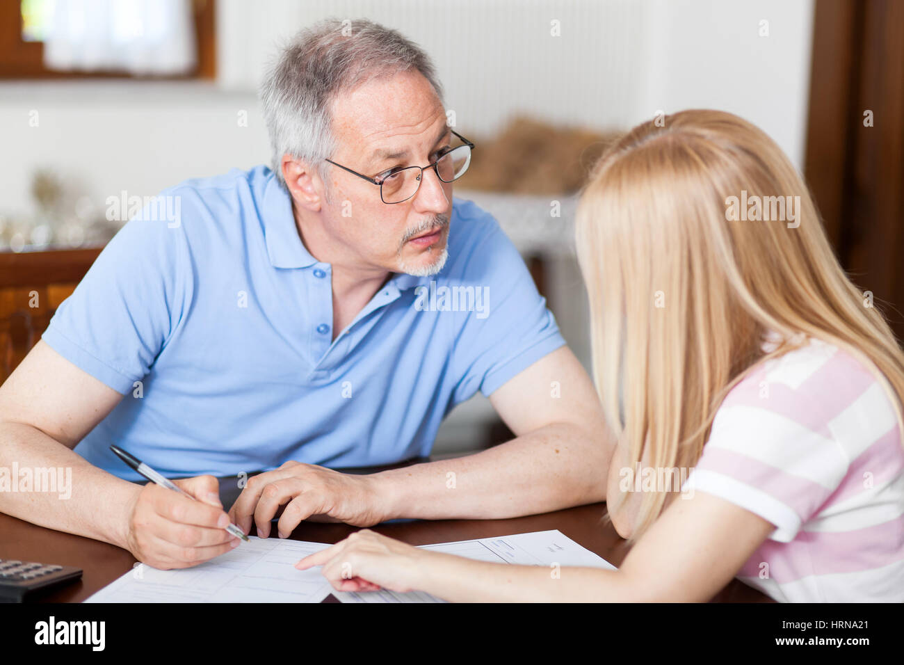 Mature couple checking finances while looking at bills Stock Photo