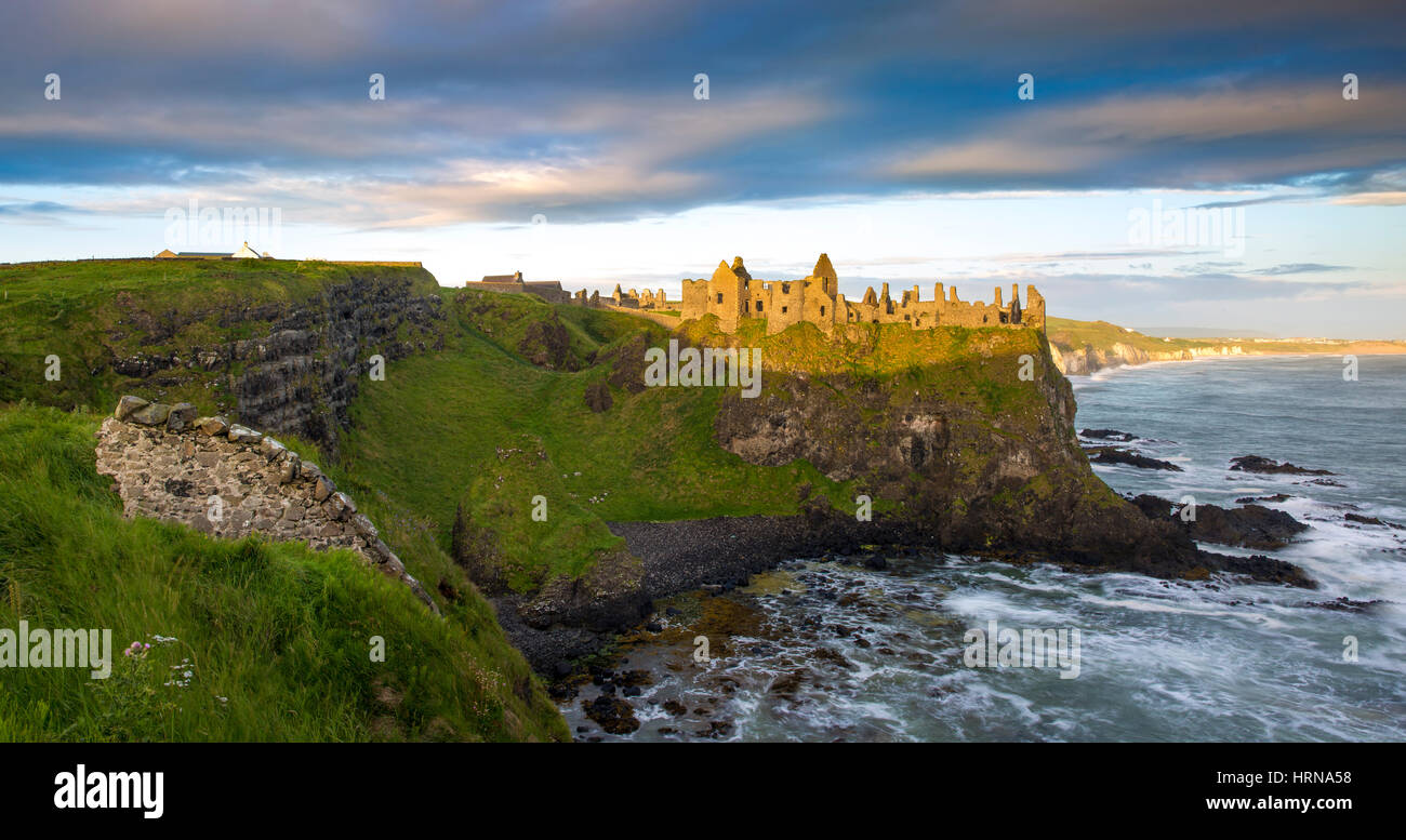 Sunrise over Dunluce Castle along northern coast of County Antrim, Northern Ireland, UK Stock Photo