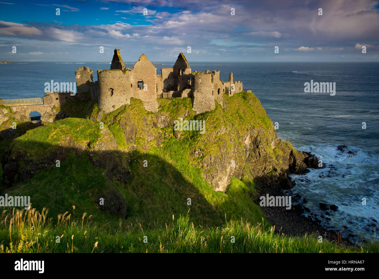 Sunrise over Dunluce Castle along northern coast of County Antrim, Northern Ireland, UK Stock Photo