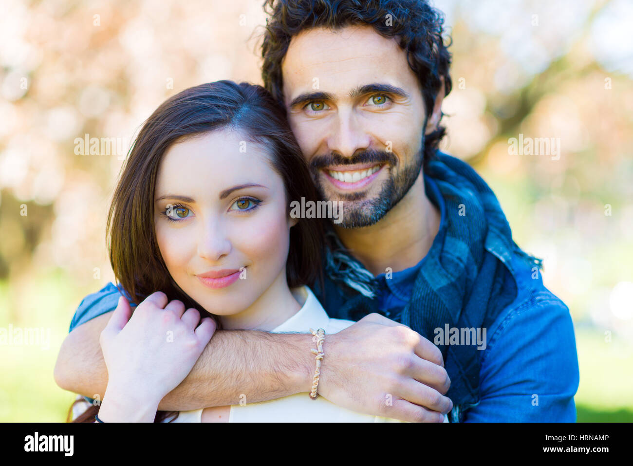 Young couple relaxing on the grass in the park Stock Photo - Alamy