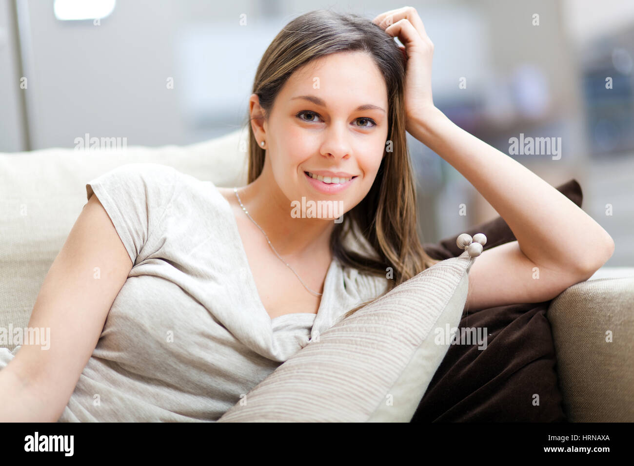 Young woman relaxing on the couch Stock Photo - Alamy