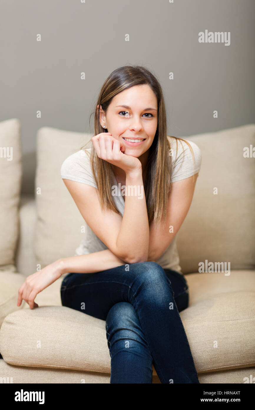 Young woman relaxing on the couch Stock Photo - Alamy