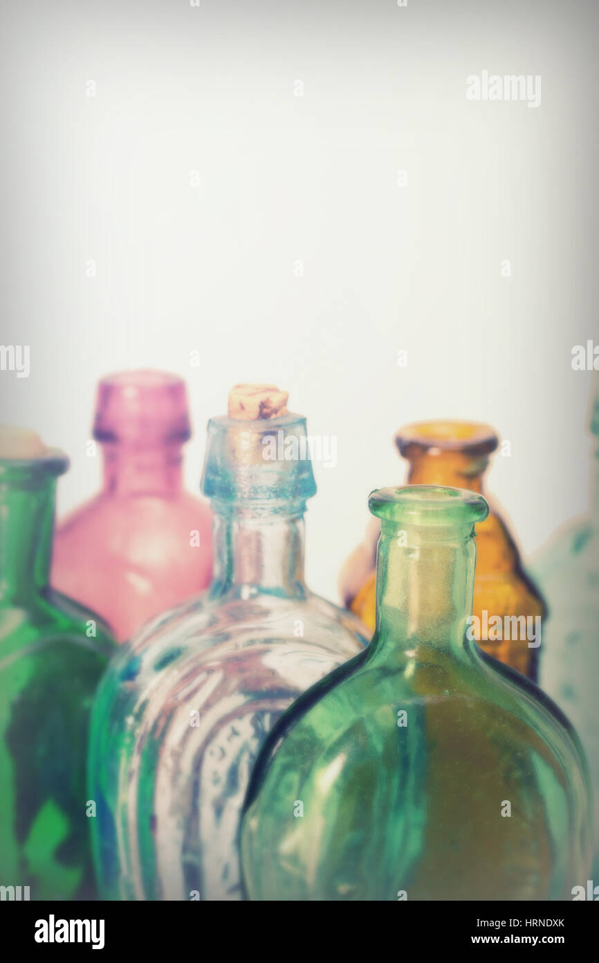 Old colourful vintage bottles against a white background Stock Photo
