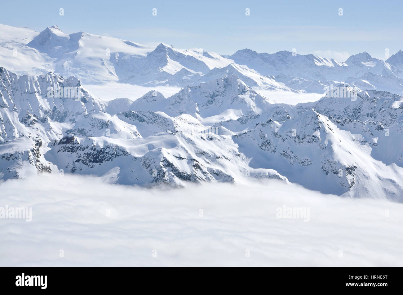Alpine snow covered peak in the Alps at winter Stock Photo - Alamy