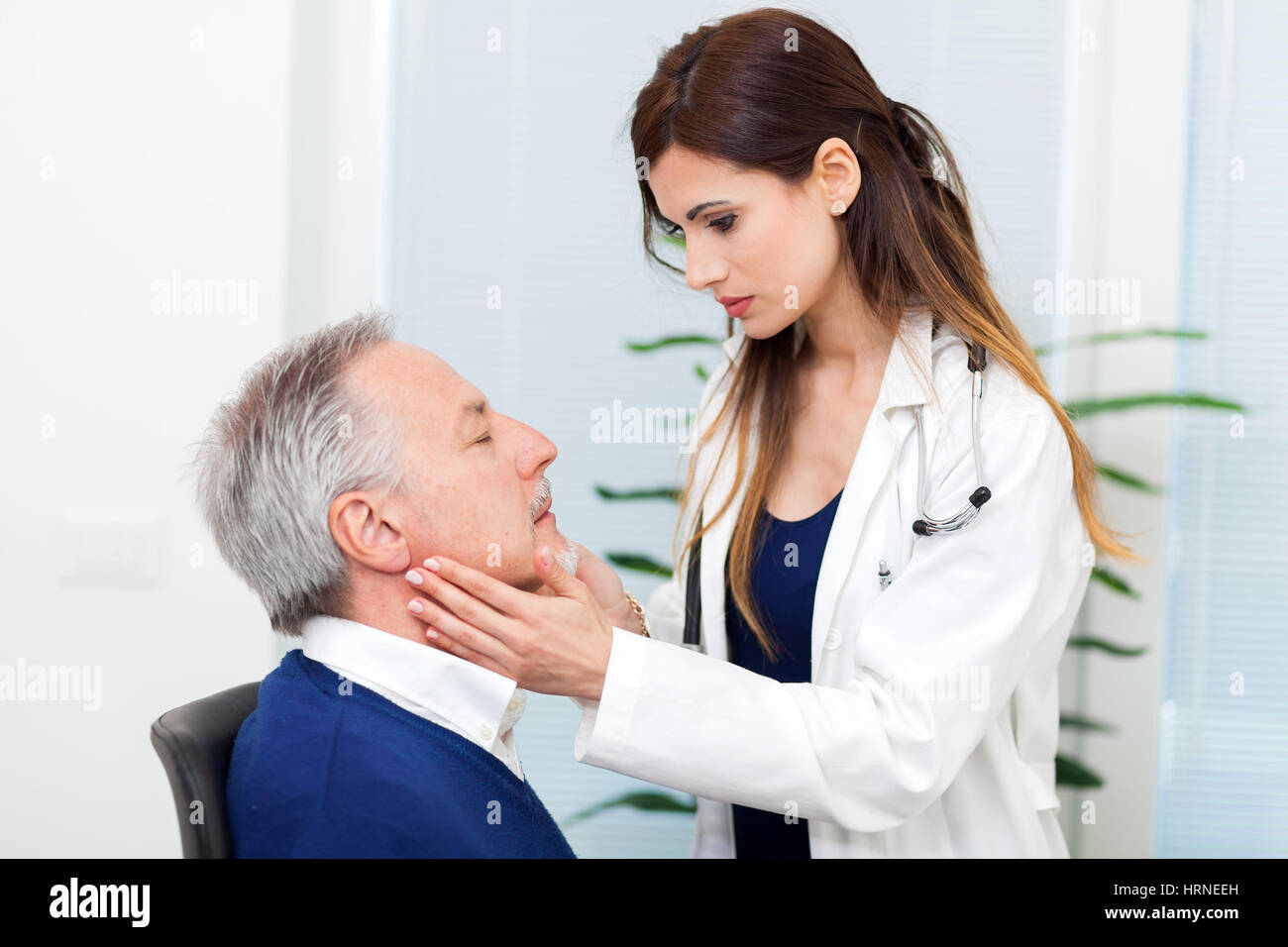 Doctor checking the lymph nodes size of her patient Stock Photo