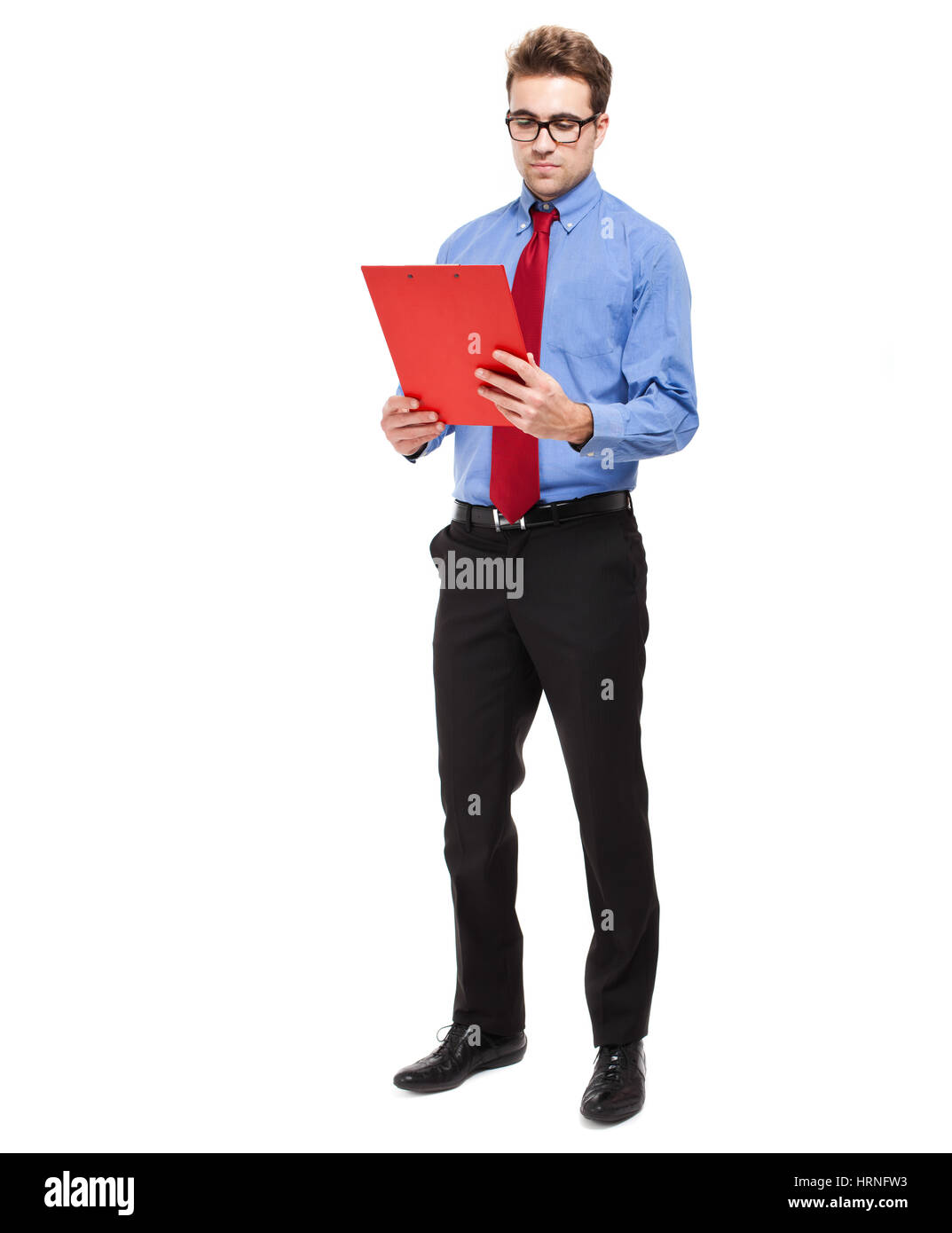 Full length businessman writing on a clipboard Stock Photo - Alamy