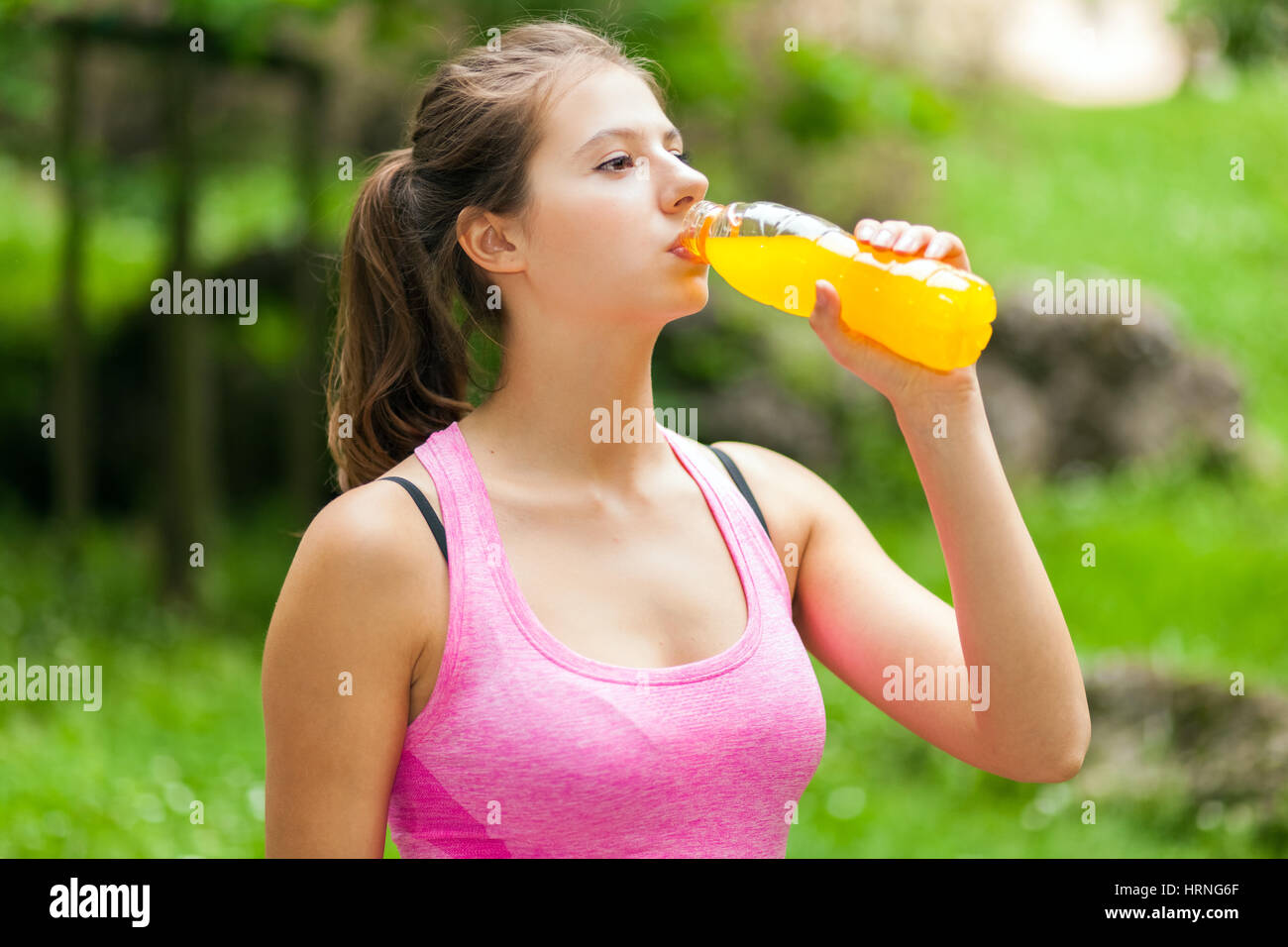 Woman drinking energy drink after running Stock Photo Alamy
