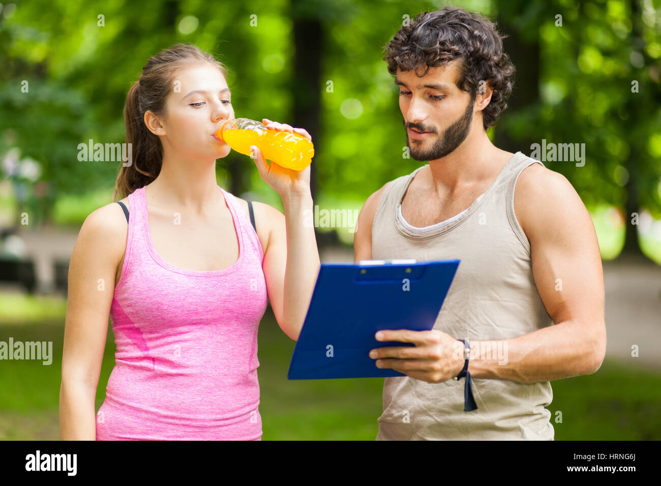 Woman drinking energy drink after running Stock Photo Alamy