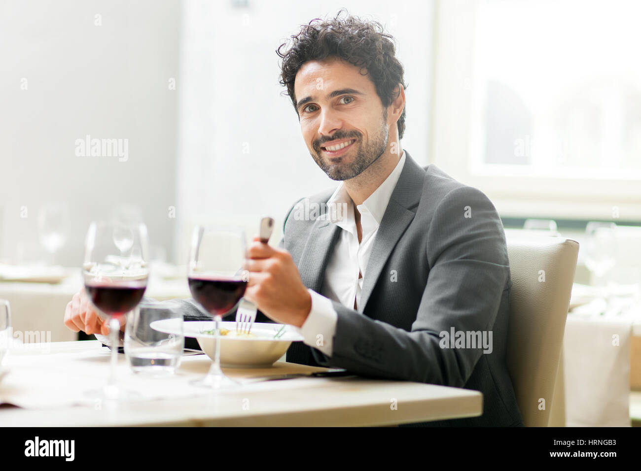 Man tasting a glass of red wine in a restaurant Stock Photo - Alamy