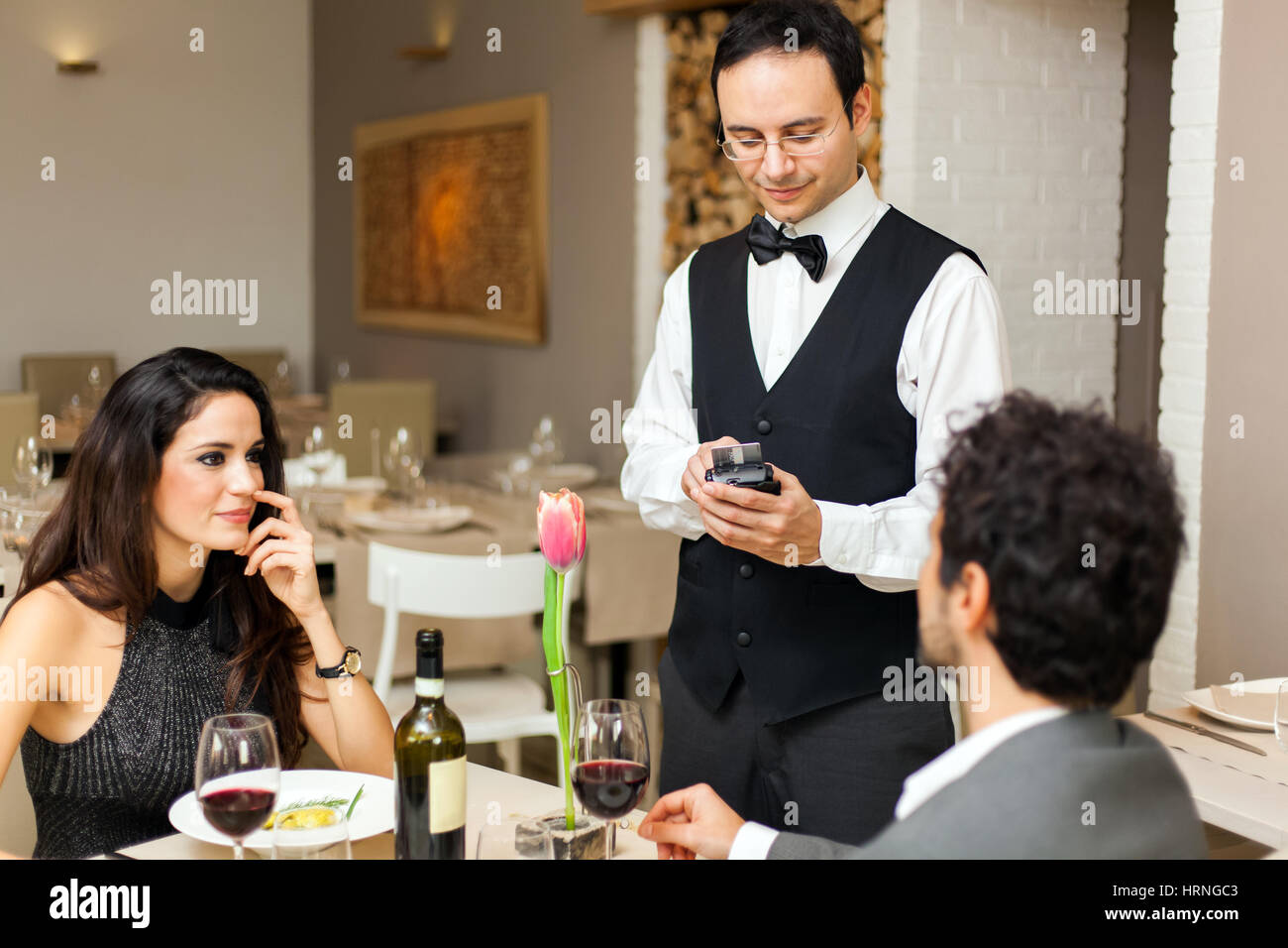 Waiter taking orders in a restaurant Stock Photo
