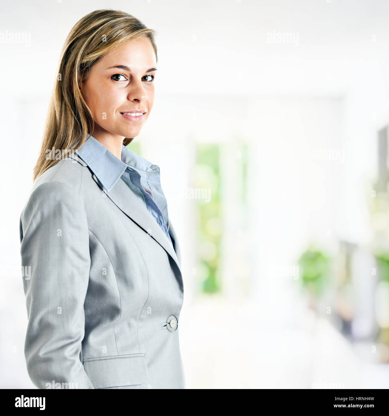 Portrait of a smiling business woman in the office Stock Photo - Alamy