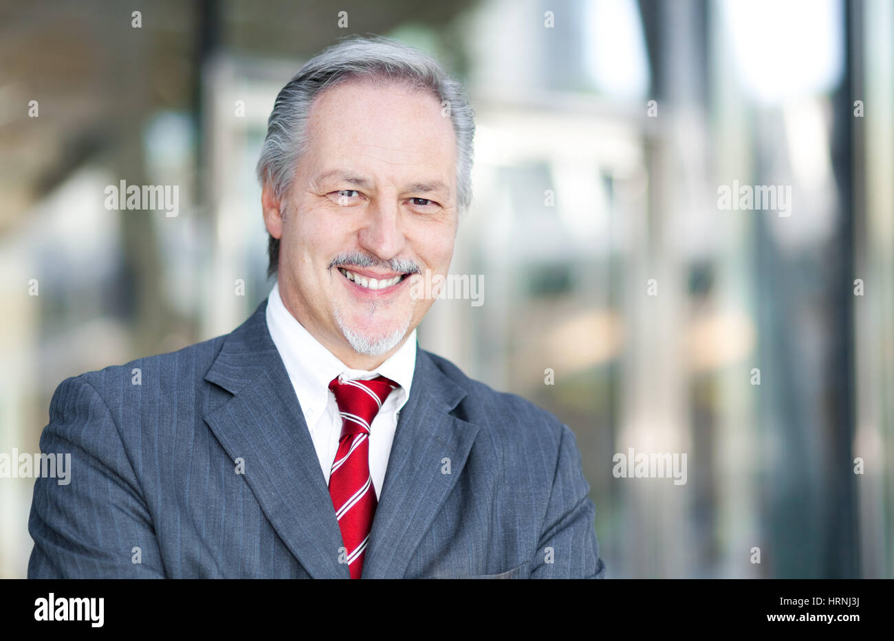 Mature businessman portrait in the office Stock Photo - Alamy