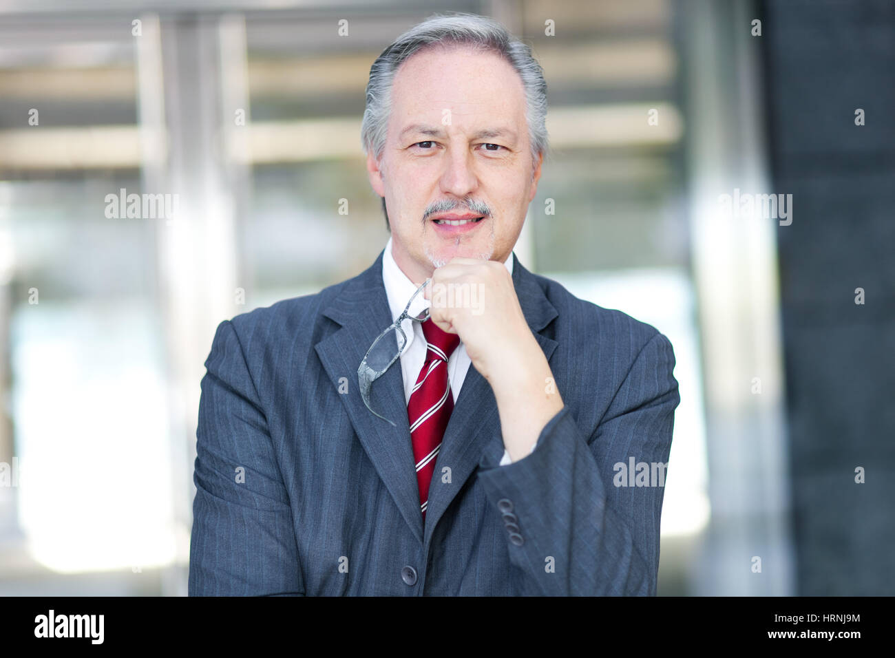 Mature businessman portrait in the office Stock Photo - Alamy