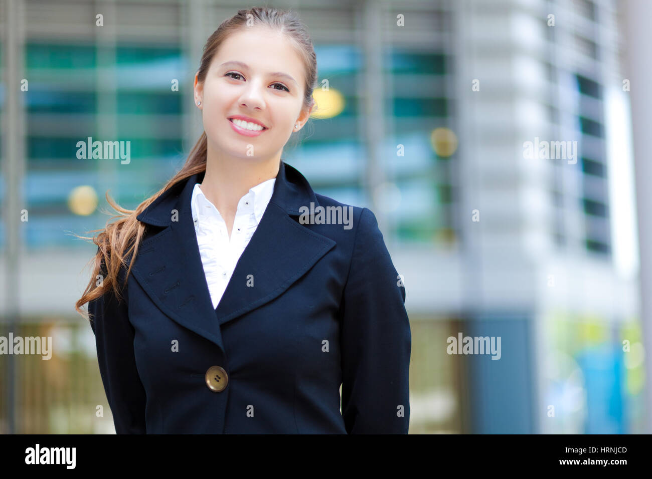 Portrait of a young smiling business woman outdoor Stock Photo - Alamy