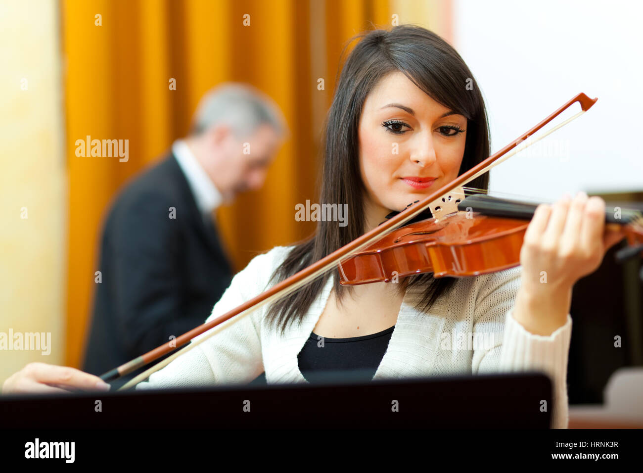 Beautiful woman playing violin Stock Photo