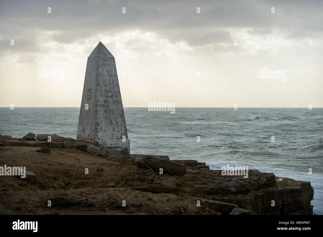 Rough seas and stormy skies off of Portland Bill behind the monument, Portland, Dorset, UK Stock Photo