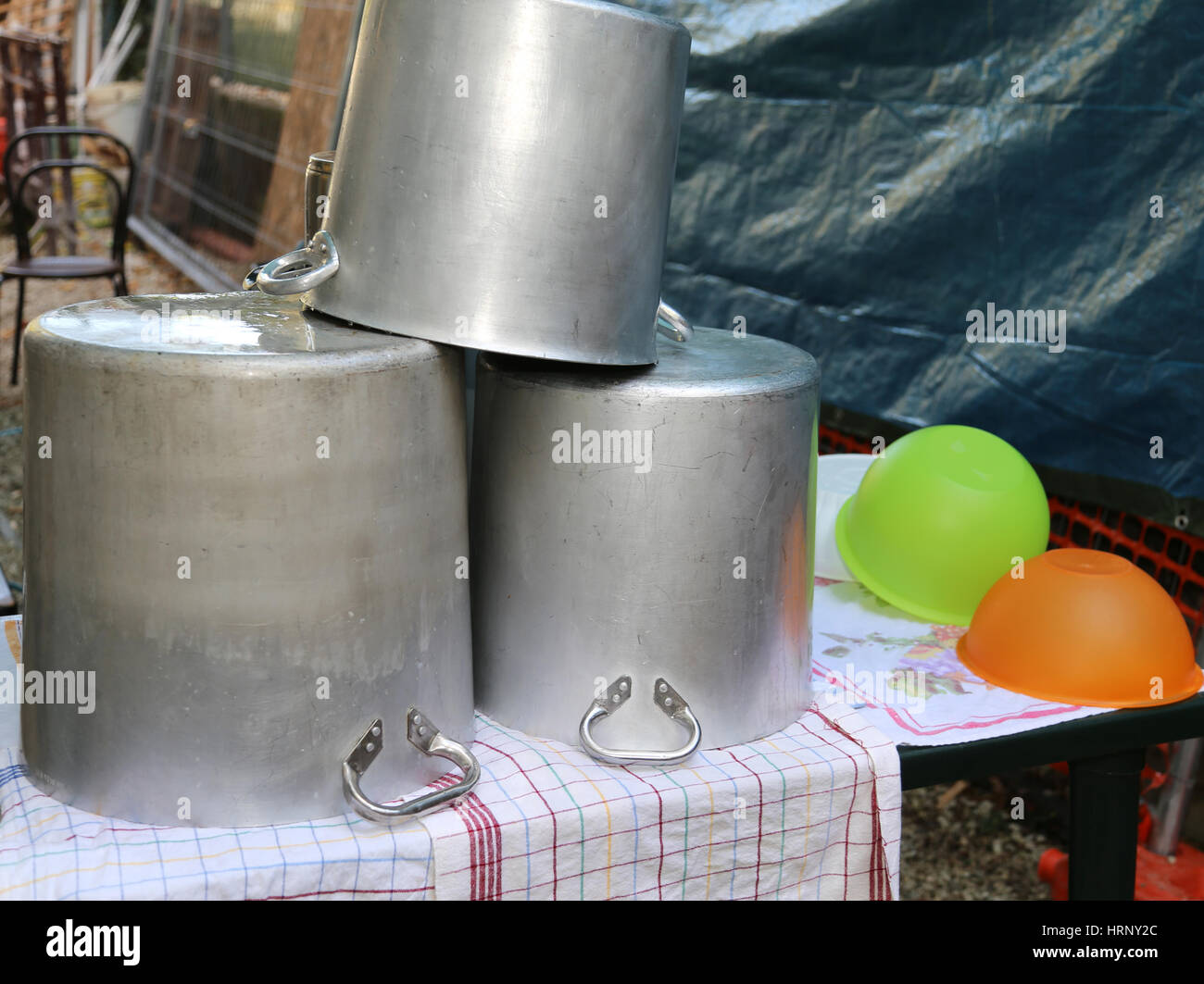 many big pots to dry and terrines in a camp kitchen Stock Photo