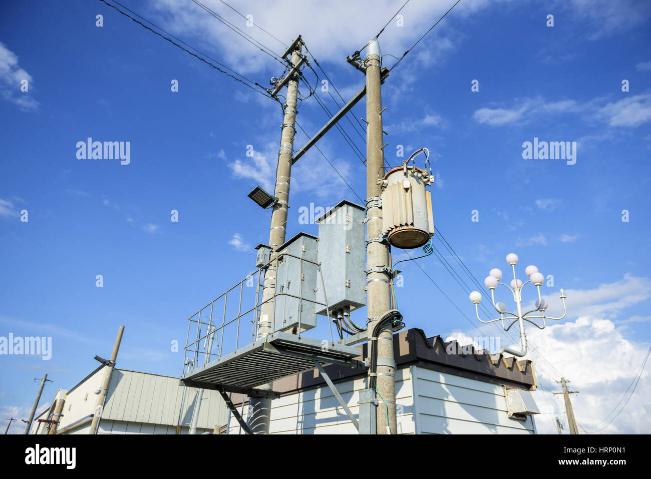 electric post against blue sky in Japan Stock Photo