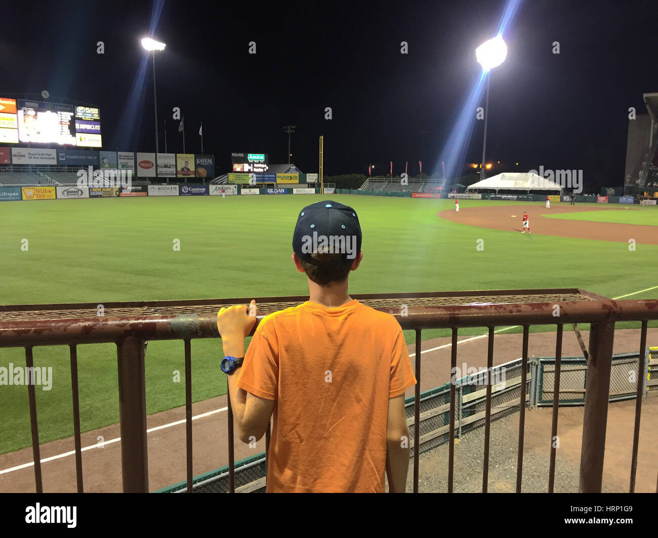 Boy watches minor league baseball game Stock Photo Alamy