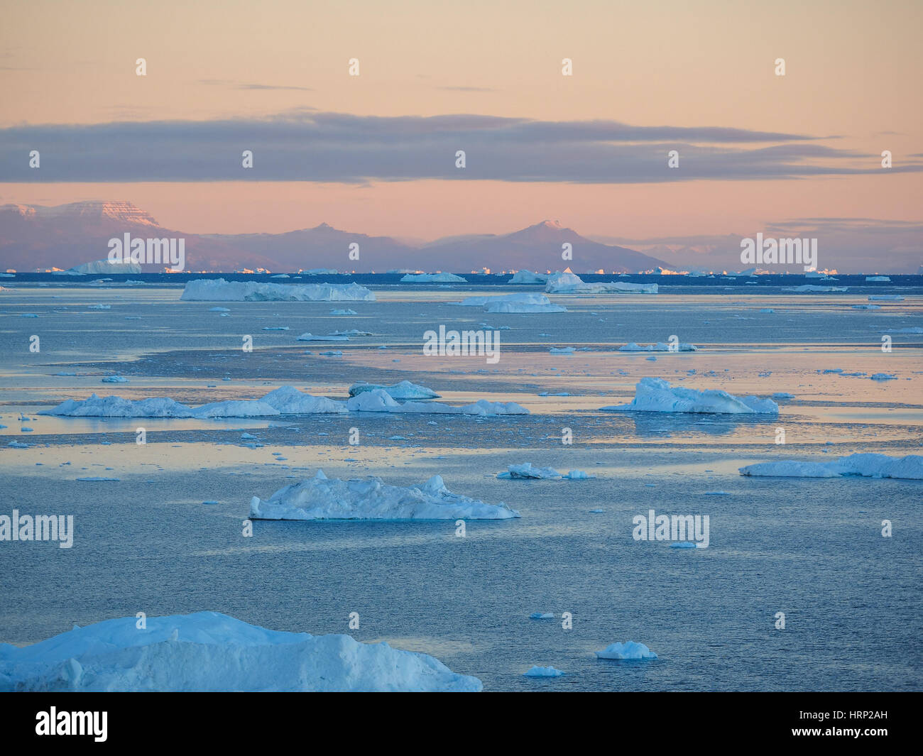 Greenland. Centuries-old thicknesses of glaciers. Icebergs of unusual forms. Research of a phenomenon of global warming Stock Photo