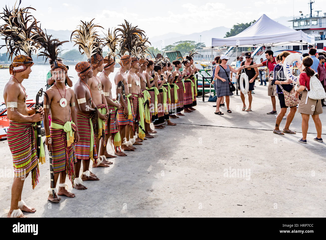 Locals in traditional dress welcome passengers from acruise ship in Dili, East Timor, Stock Photo