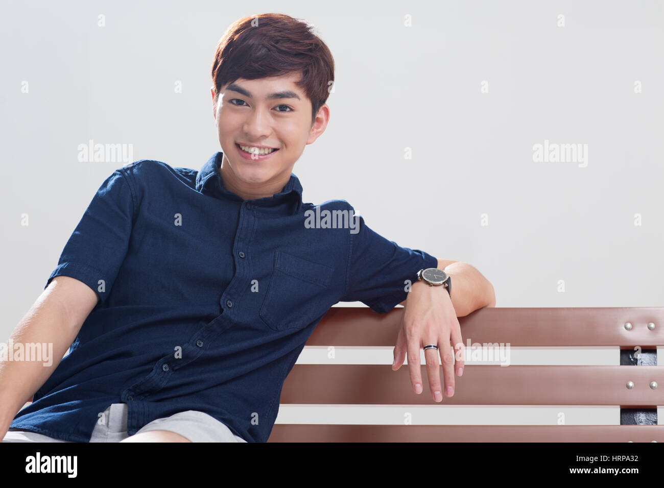 Young indian men sitting bench hi-res stock photography and images - Alamy