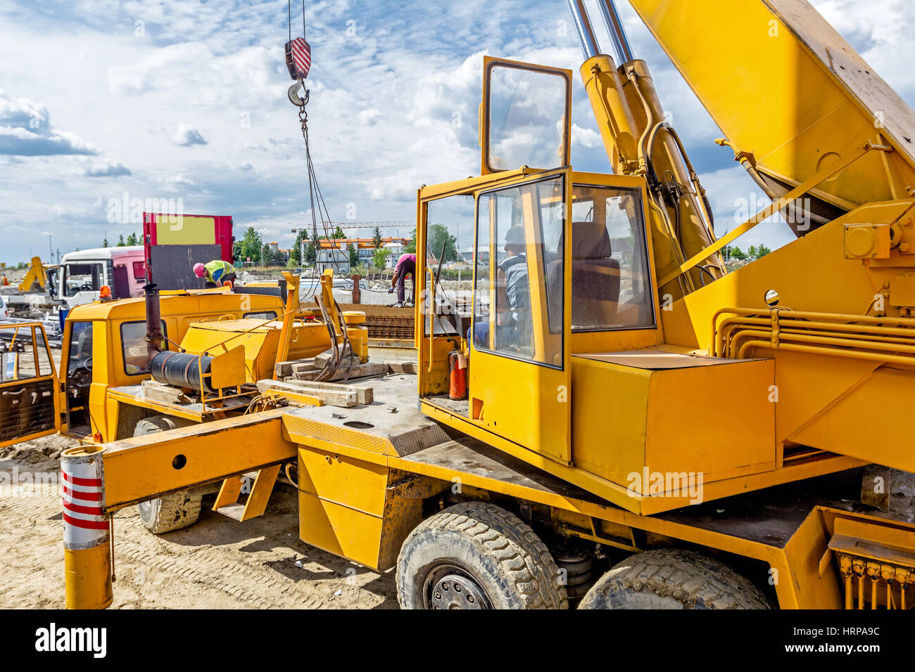 Side view on open cabin of the yellow mobile crane with erected long ...