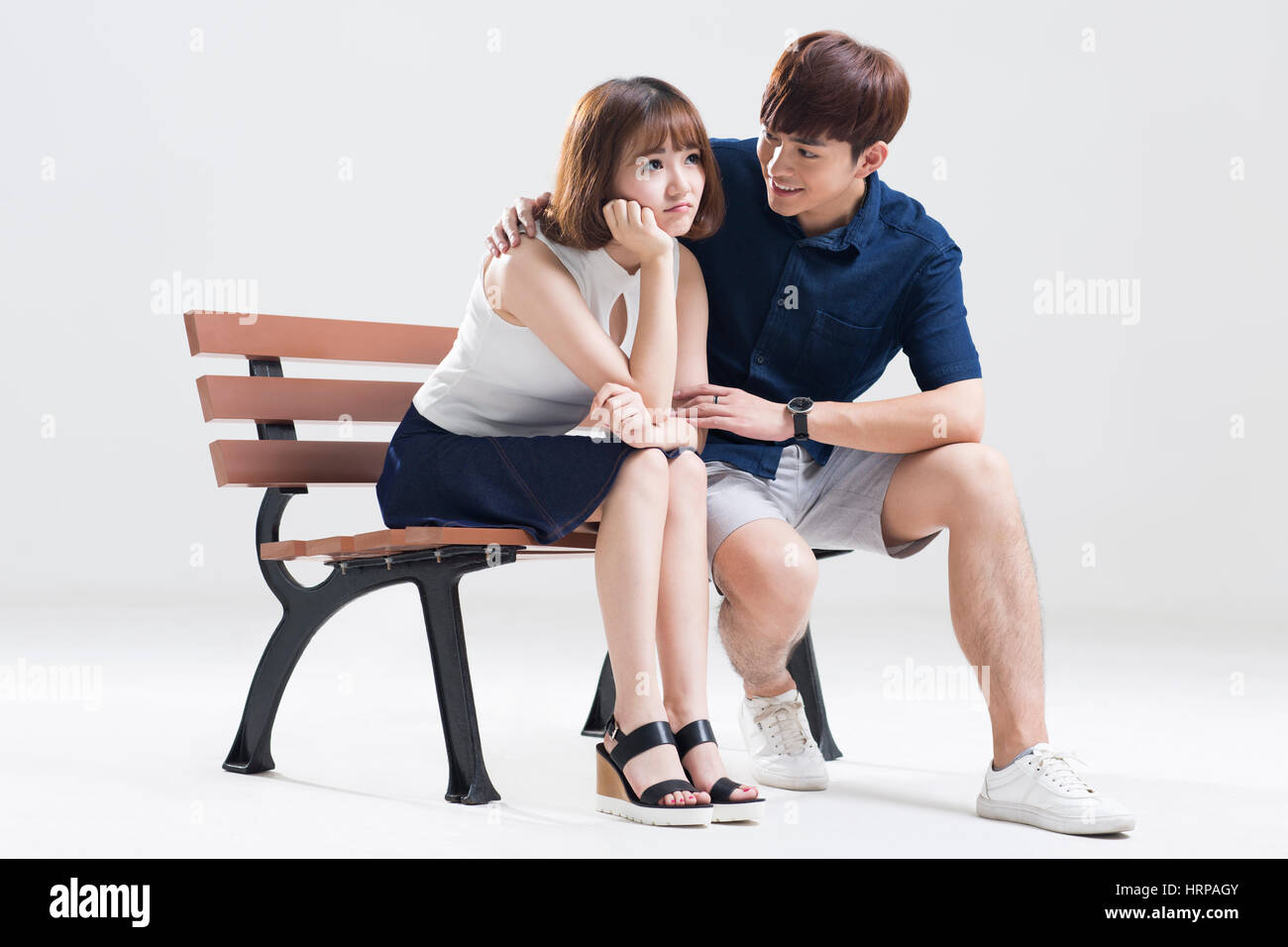 Young man comforting girlfriend Stock Photo - Alamy