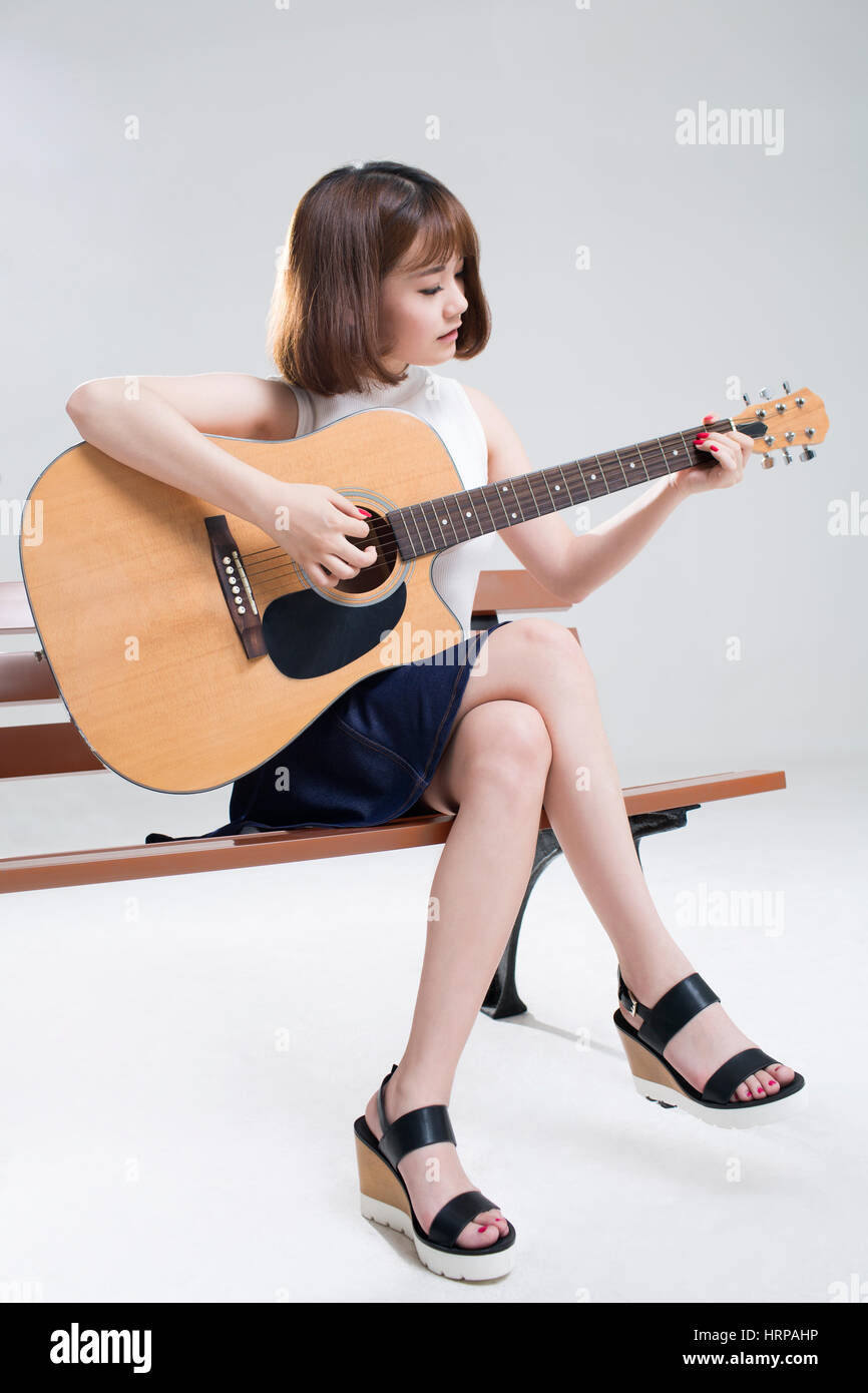 Beautiful young girl posing with guitar featuring guitar, music, and  teacher | People Images ~ Creative Market