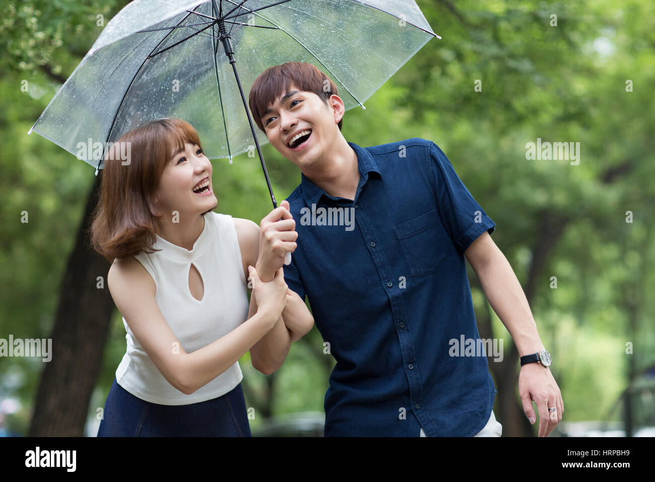 Loving couple in rain umbrella hi-res stock photography and images - Alamy