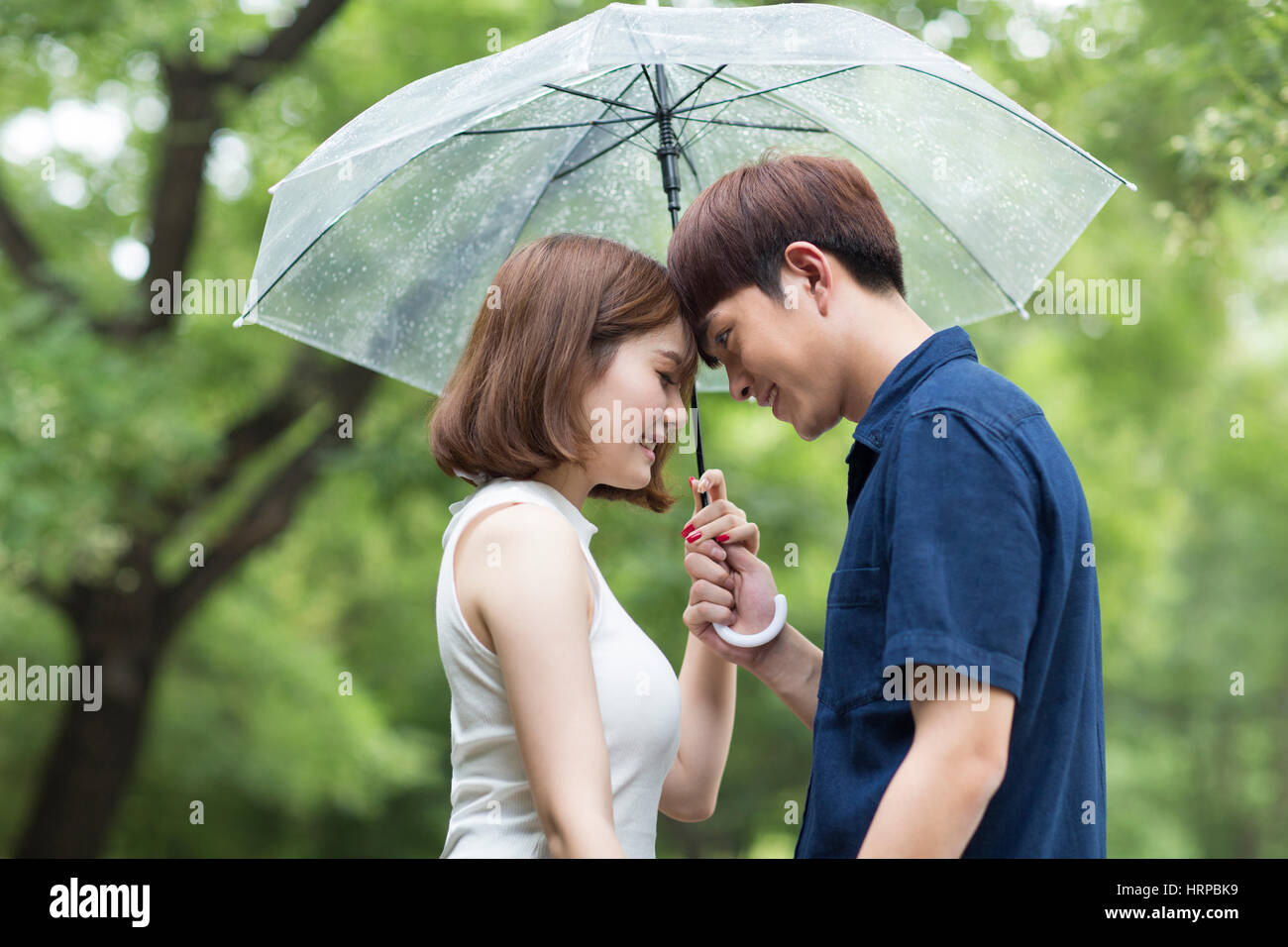 Loving couple in rain umbrella hi-res stock photography and images - Alamy