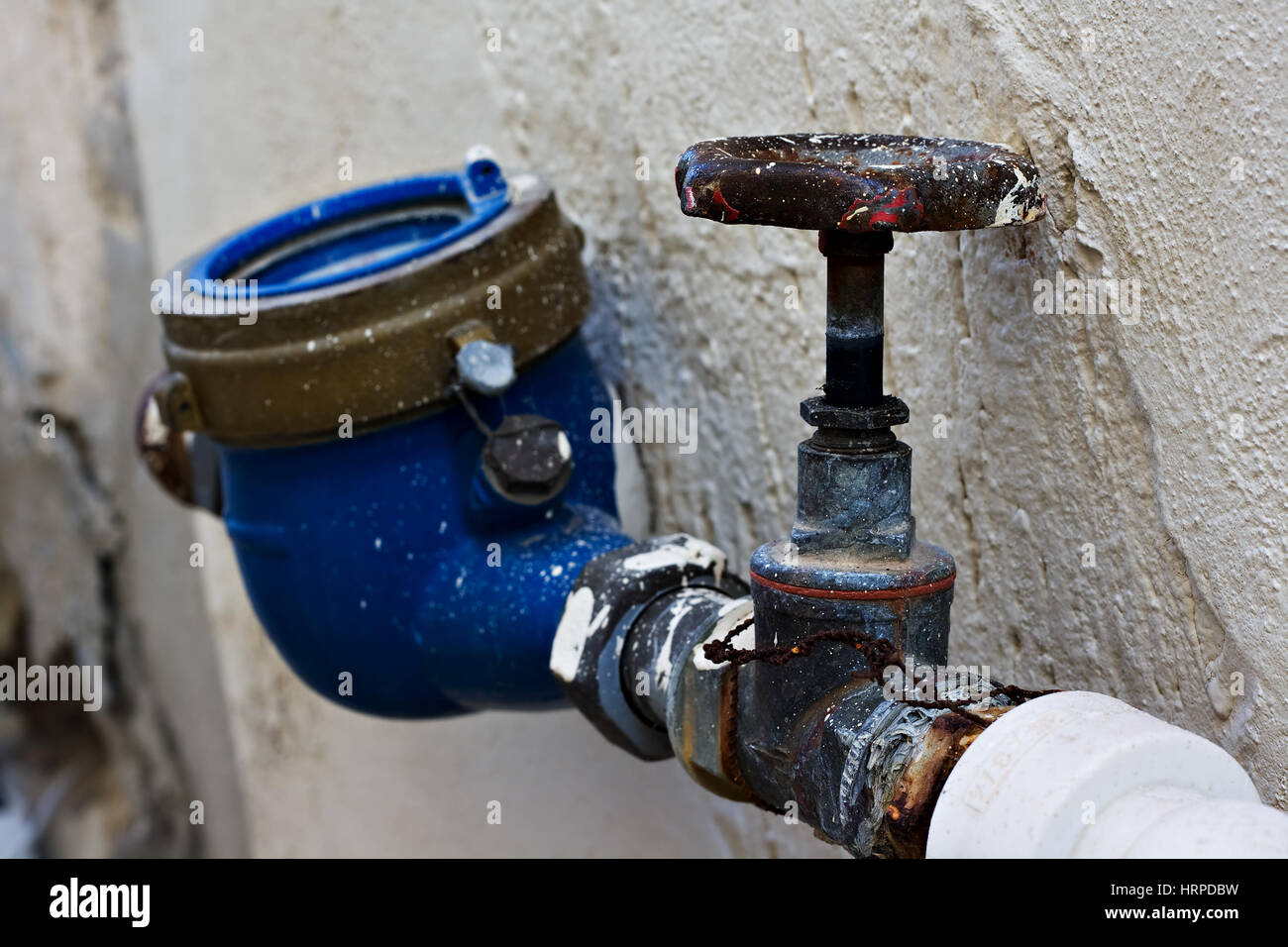 Rusty old stop cock valve and water meter Stock Photo - Alamy