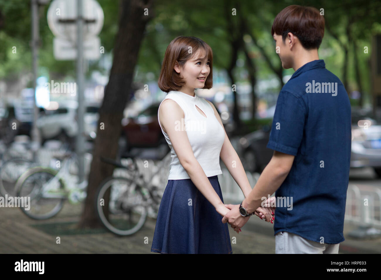 Happy young couple holding hands Stock Photo - Alamy
