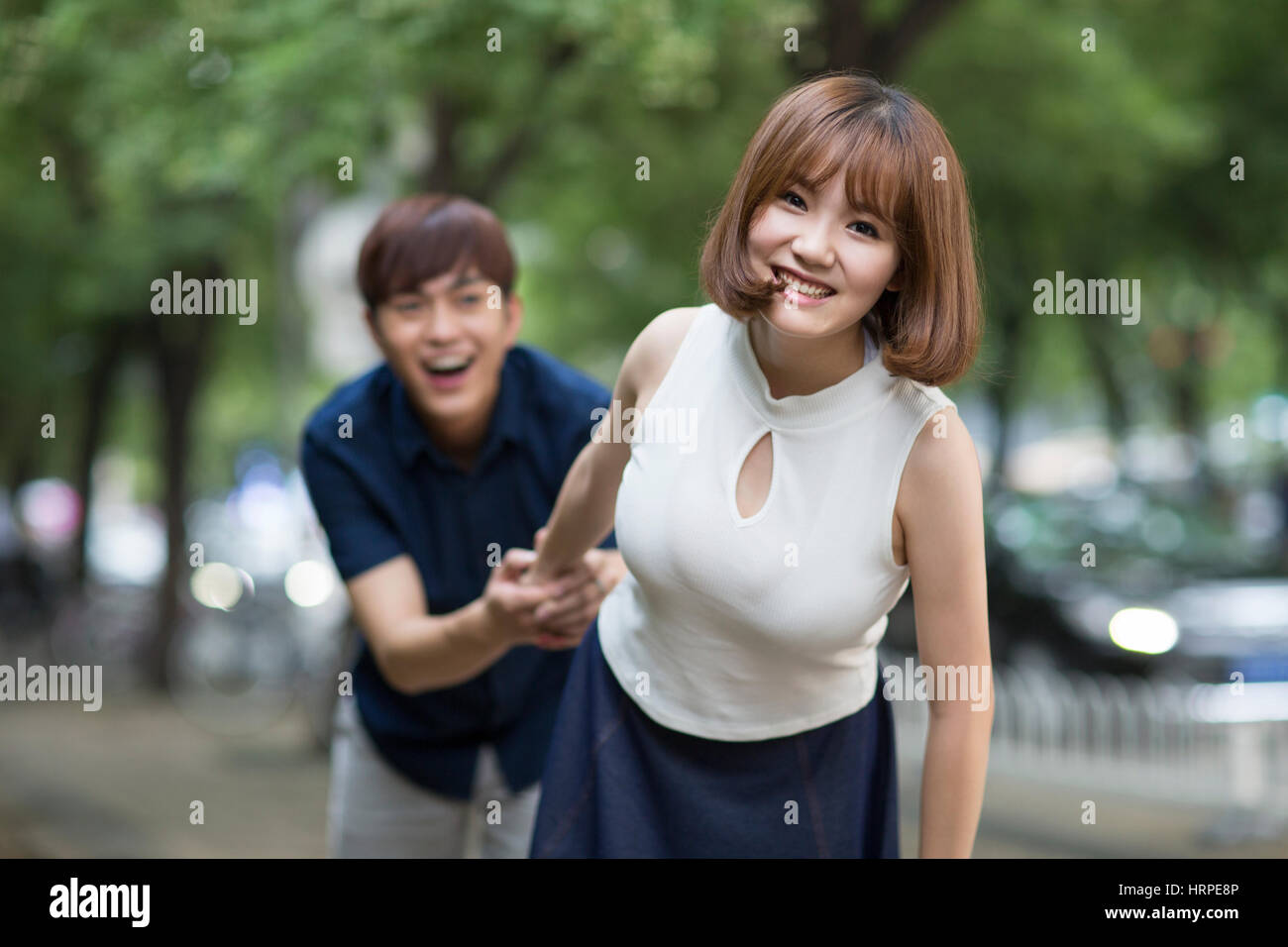 Happy young couple holding hands Stock Photo - Alamy