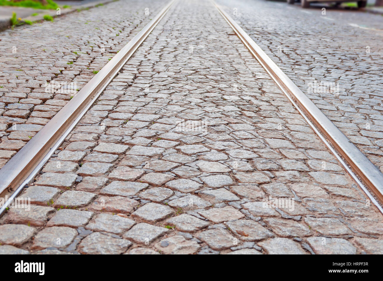 Old rail lines on cobbled road surface Stock Photo Alamy