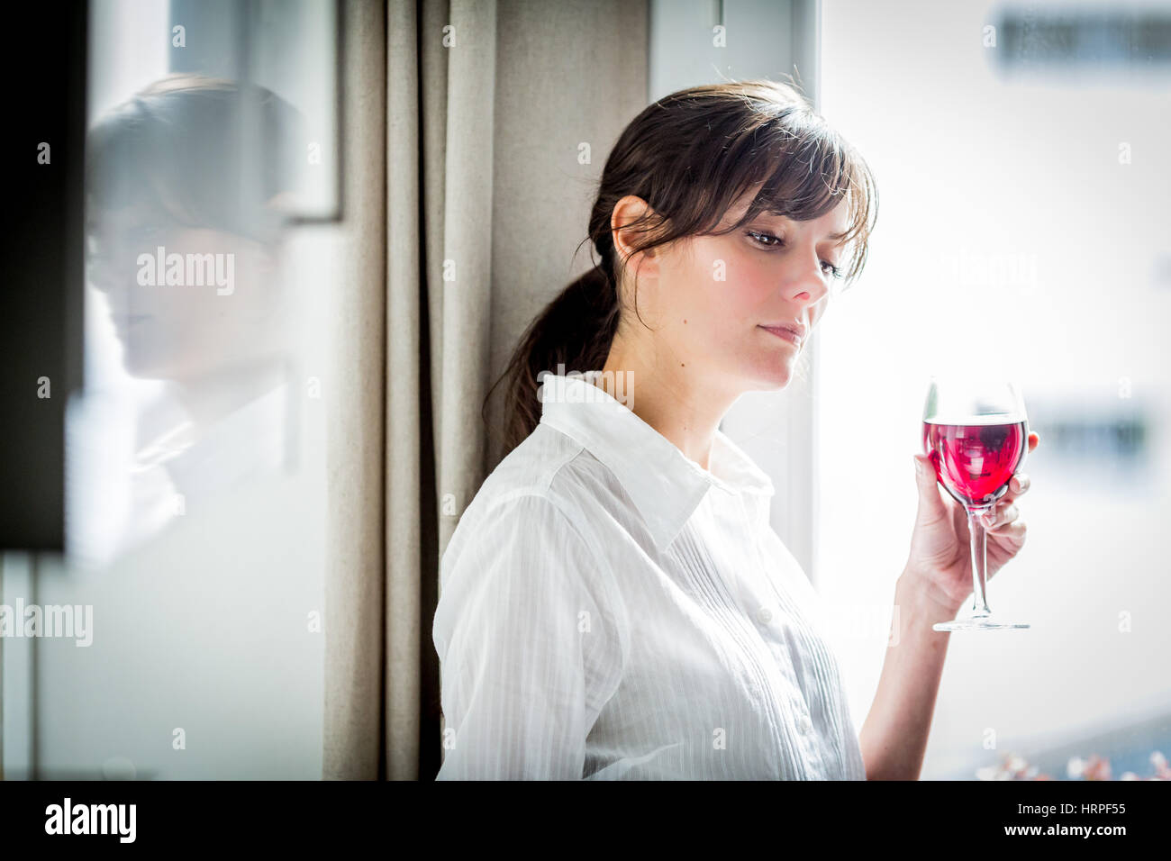 Woman drinking a glass of red wine Stock Photo - Alamy