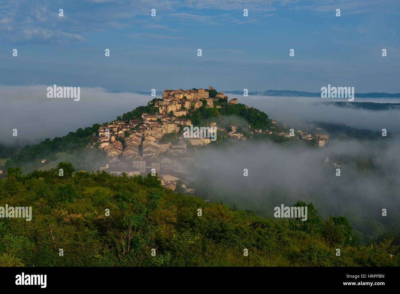 Medieval village of Cordes-sur-Ciel in Occitanie, France. View with early morning mist. Stock Photo