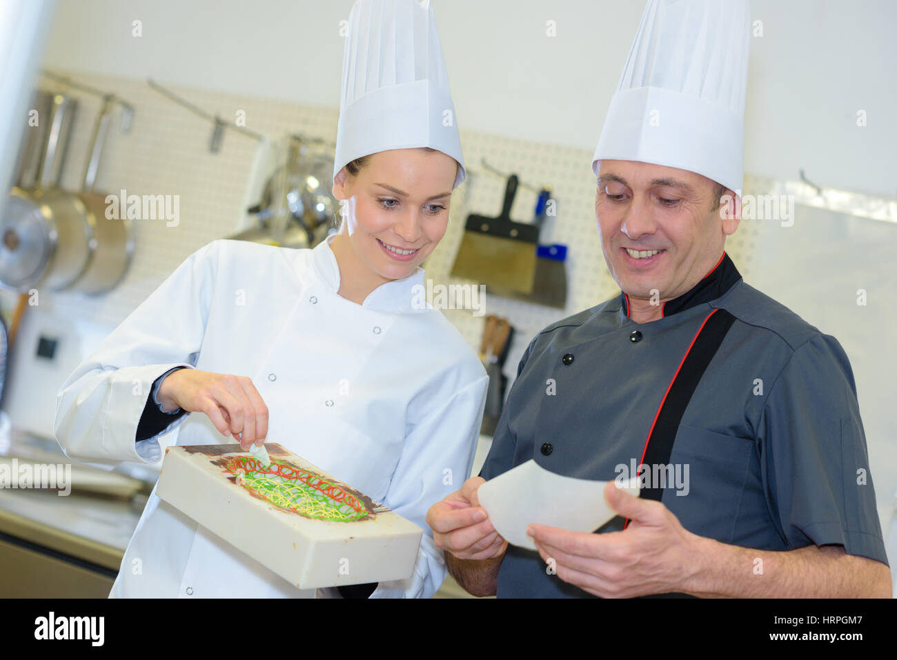 Pastry Chef And Assistant Preparing Cake Stock Photo Alamy pastry-chef-and-assistant-preparing-cake-stock-photo-alamy