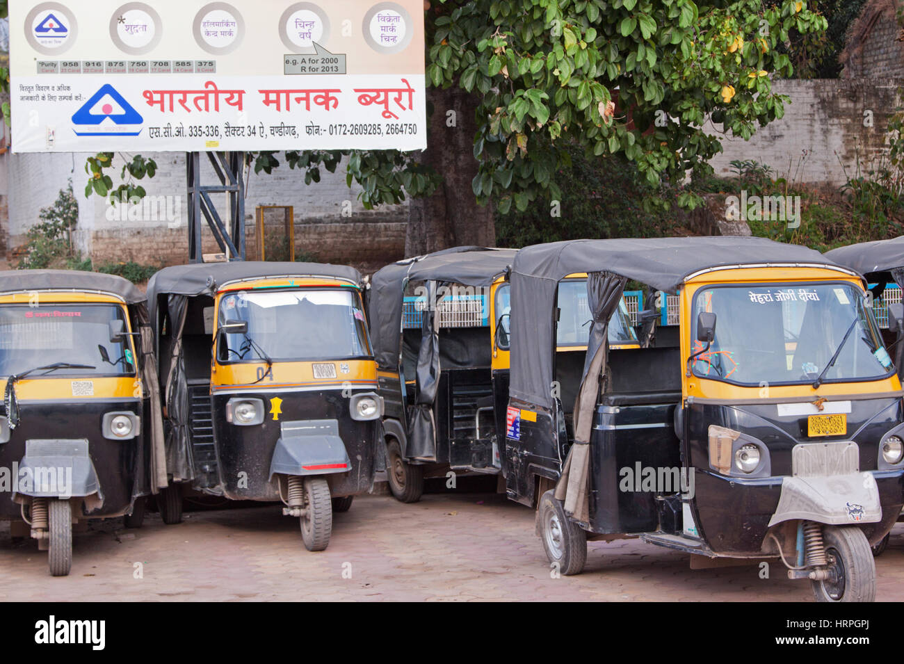 Fleet of auto rickshaws, commonly known as tuktuks, awaiting passengers outside the railway station at Kalka, India Stock Photo