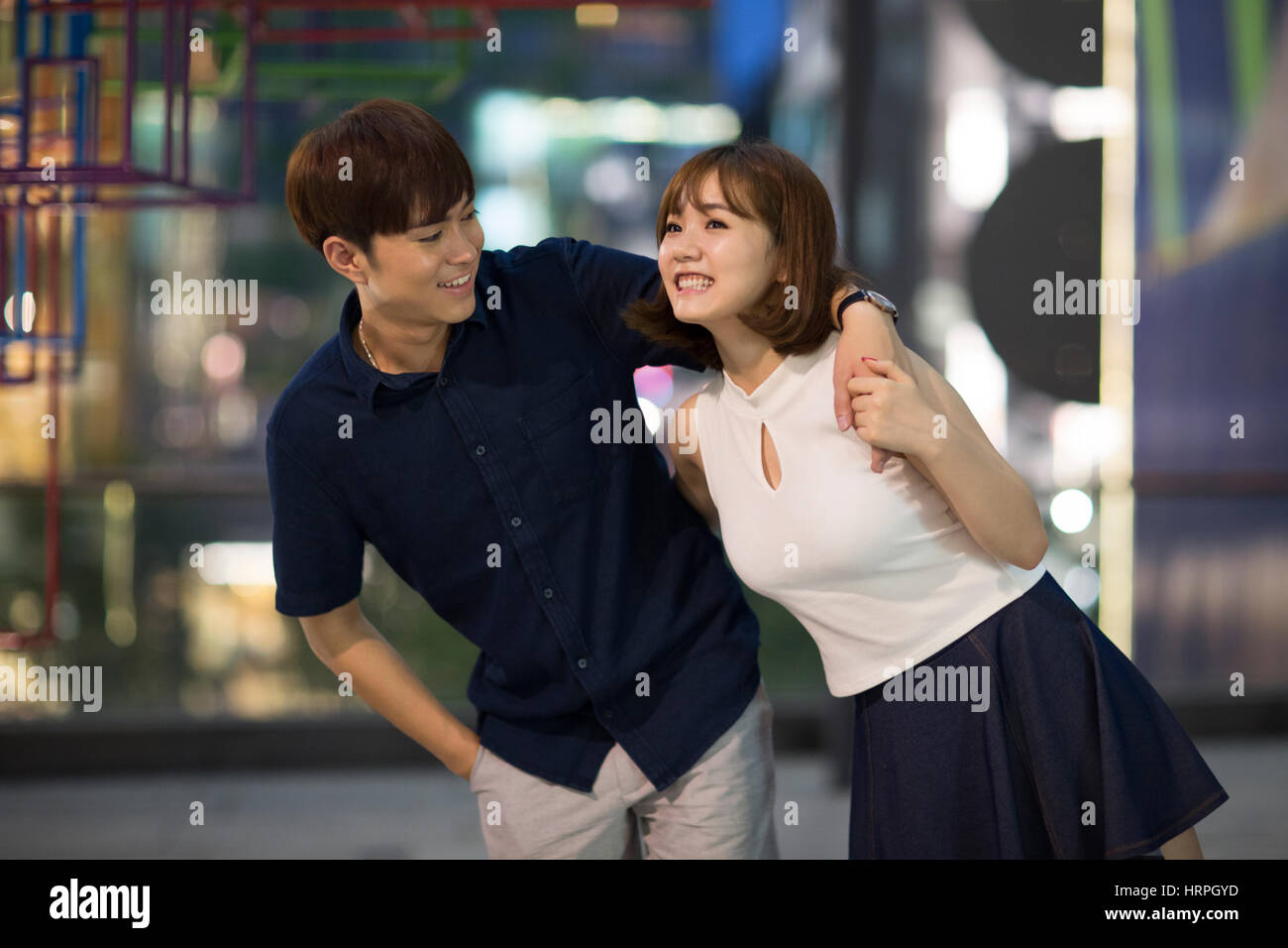 Two happy young women walking hand hand city hi-res stock photography ...