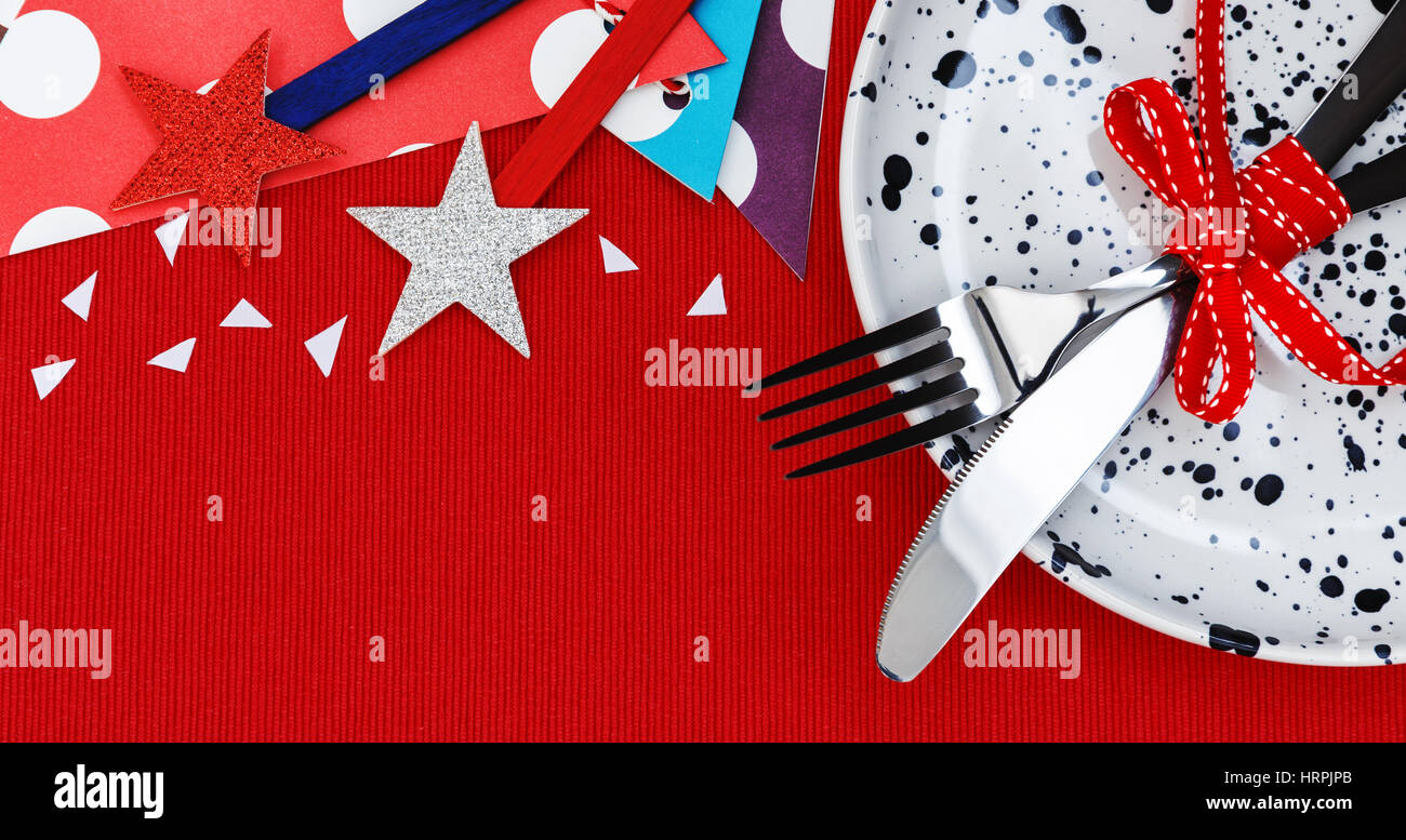 Party and celebration background with fork and knife on plate Stock Photo